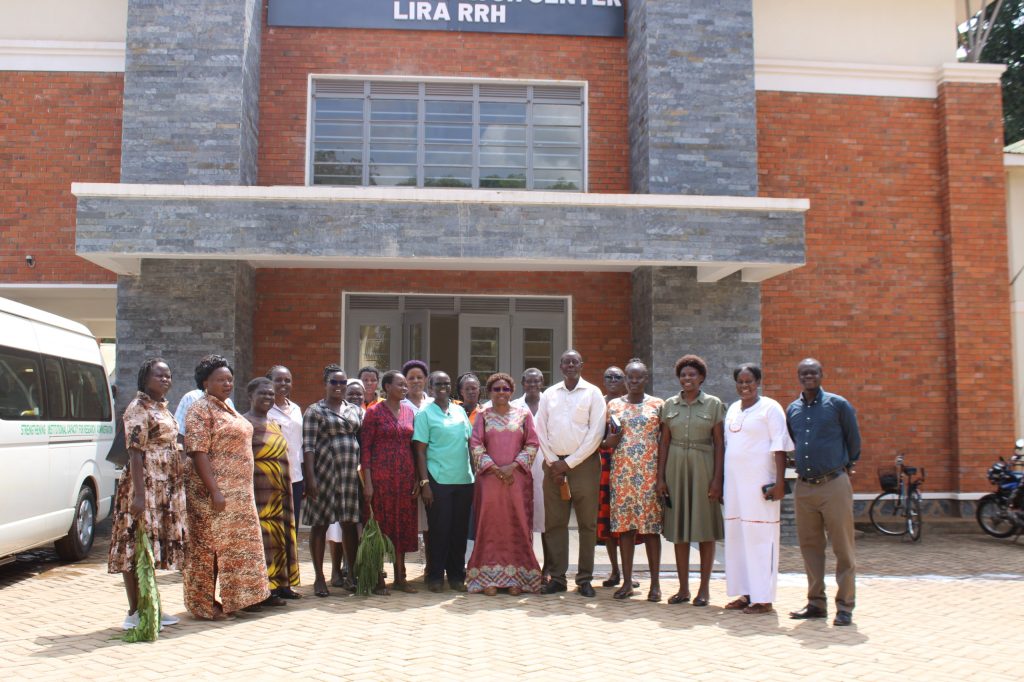 Hon Dr Jane Ruth Aceng in the Middle(Maroon Dress) in a group photo with LRRH Staff